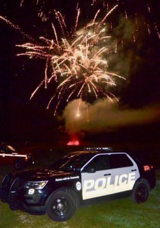 Police Cruiser with Fireworks in the background